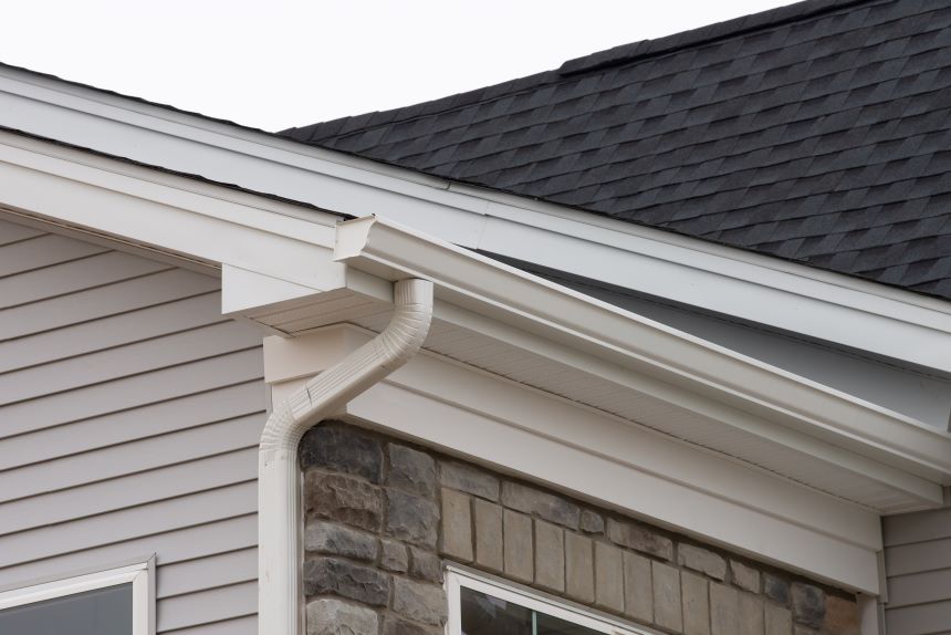 Stock image of cream colored gutter on a residential home